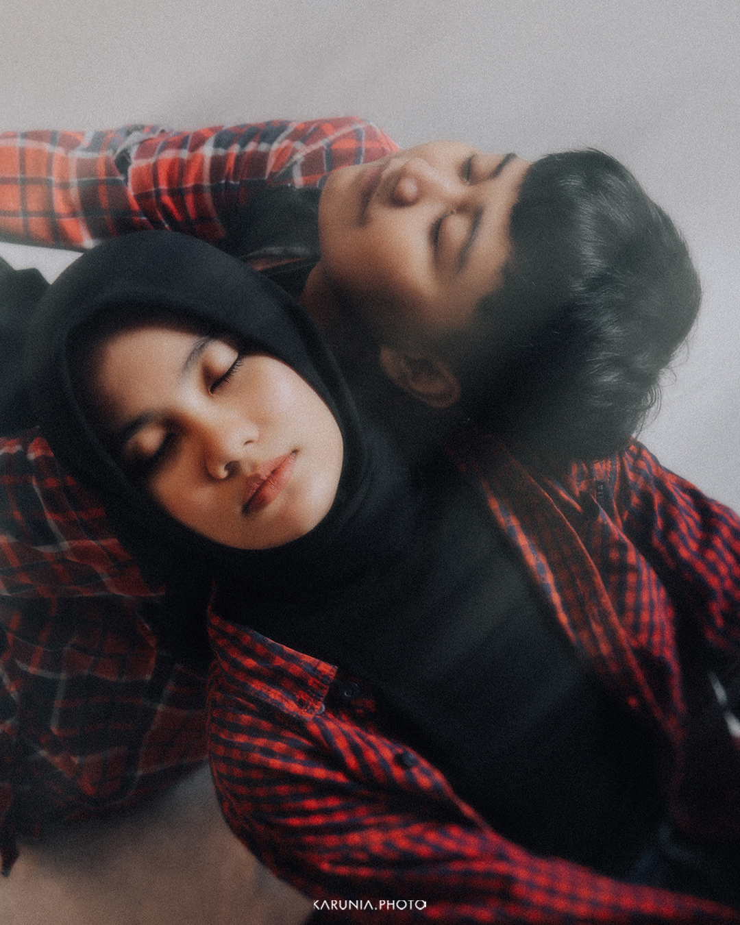 Bride and groom-to-be holding hands and walking along city streets with romantic bokeh lights